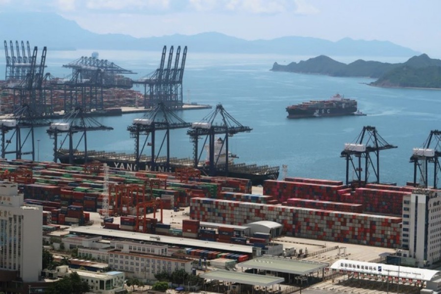 FILE PHOTO: A cargo ship carrying containers is seen near the Yantian port in Shenzhen, following the novel coronavirus disease (COVID-19) outbreak, Guangdong province, China May 17, 2020. Picture taken May 17, 2020. REUTERS