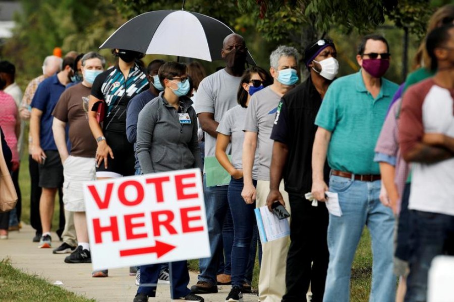 Voters wait in line to enter a polling place and cast their ballots on the first day of the state's in-person early voting for the general elections in Durham, North Carolina, US on October 15, 2020 — Reuters/Files