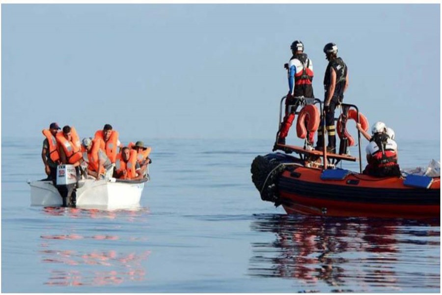 FILE PHOTO: Migrants are seen on board a fiberglass boat in the Mediterranean Sea, off the Libyan Coast, Aug 12, 2018. REUTERS