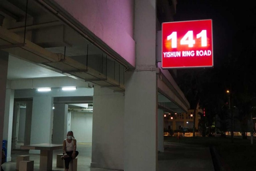 People sit at the void deck of a public housing block in Yishun, Singapore, Oct 28, 2020. REUTERS