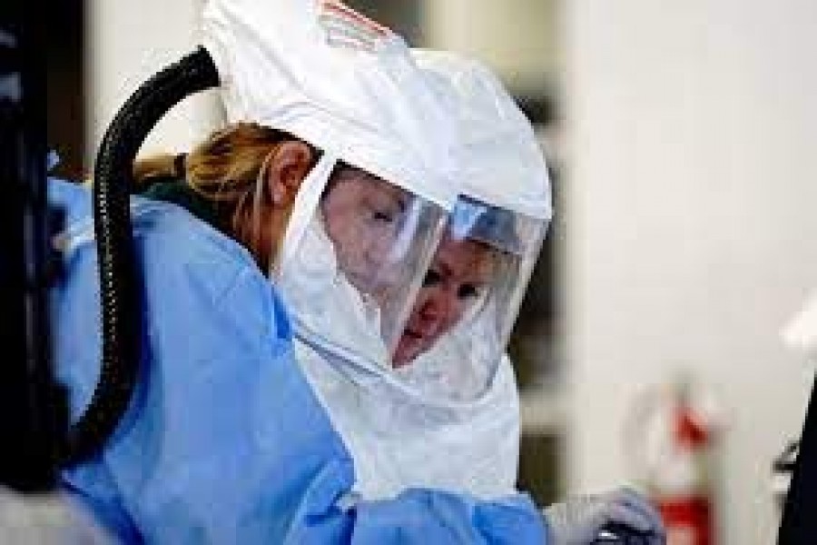 Healthcare workers wearing powered air purifying respirator (PAPR) hoods process COVID-19 test samples at a drive-thru testing site operated by Avera Health inside the former Silverstar Car Wash, as the coronavirus disease (Covid-19) outbreak continues in Sioux Falls, South Dakota, US on October 28, 2020 — Reuters/Files