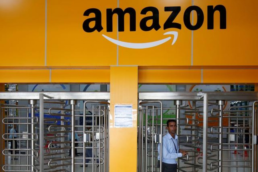 An employee of Amazon walks through a turnstile gate inside an Amazon Fulfillment Centre (BLR7) on the outskirts of Bengaluru, India, September 18, 2018. REUTERS/ Abhishek N. Chinnappa