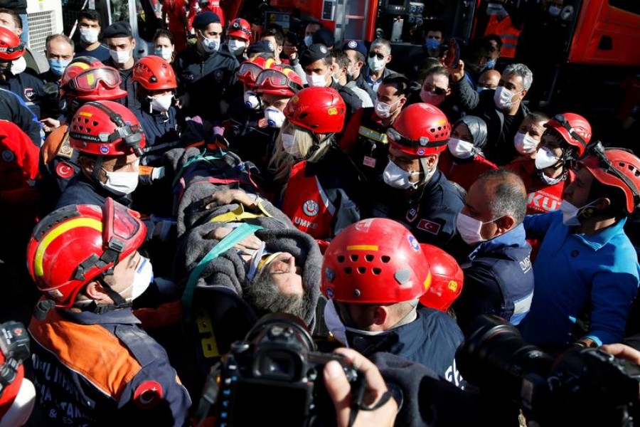 Rescue workers carry a survivor out of a collapsed building after an earthquake in the Aegean port city of Izmir, Turkey, October 31, 2020 -- Reuters