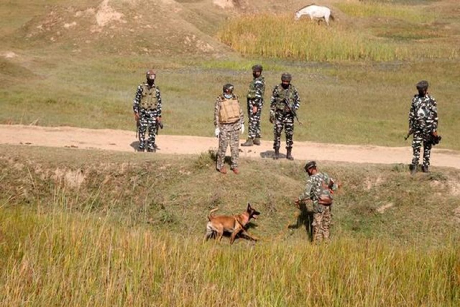 Indian security force personnel with their sniffer dog stand during a search operation after suspected militants attacked a Central Reserve Police Force (CRPF) patrolling party near Pampore, on the outskirts of Srinagar, October 5, 2020 — Reuters/Files