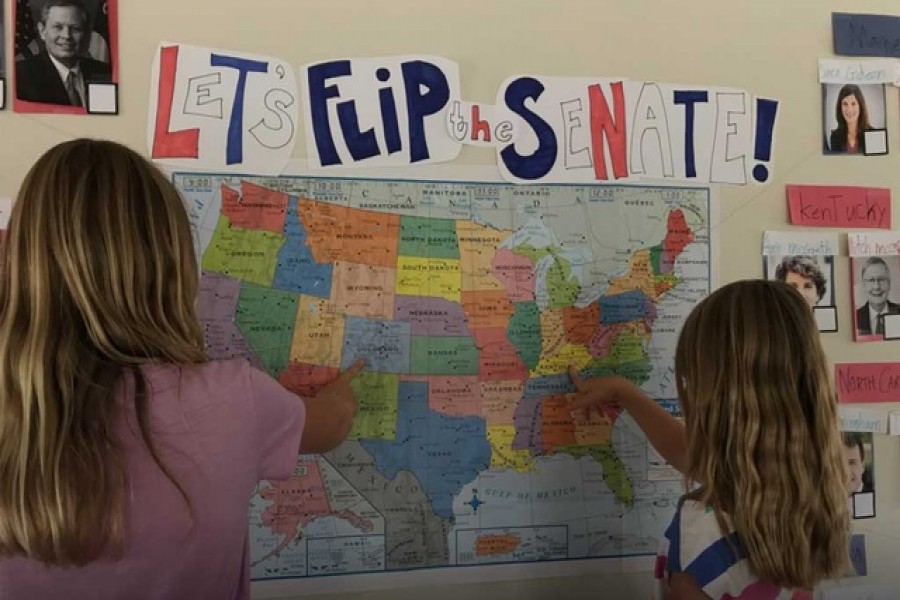 Daughters of David and Rachel Roderick use a map and candidates' pictures up on the wall to learn how the US government works in Berkeley, California, US, Aug 27, 2020. REUTERS