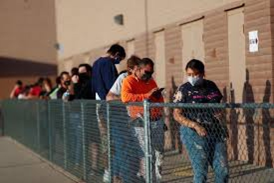 Voters line up at a polling station to vote in the 2020 US presidential election in the majority Hispanic neighborhood of Maryvale in Phoenix, Arizona, US, November 3, 2020 — Reuters