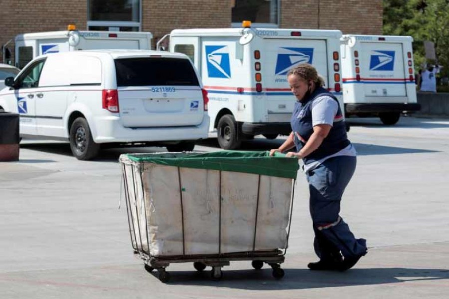 A United States Postal Service (USPS) worker pushing a mail bin outside a post office in Michigan on August 22 this year –Reuters file photo