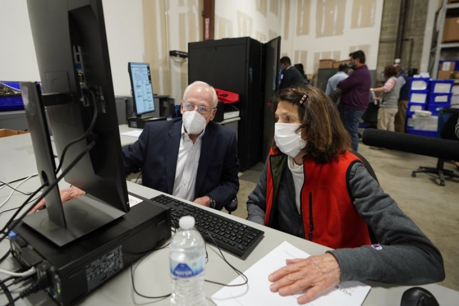 US Democratic and Republican representatives review absentee ballots at the Fulton County Election preparation Center on Wednesday, November 4, 2020 in Atlanta — AP photo