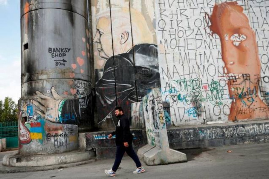 A Palestinian man walks past an anti-US President Donald Trump mural which was painted on a section of the Israeli barrier, in Bethlehem in the Israeli-occupied West Bank November 2, 2020. — Reuters