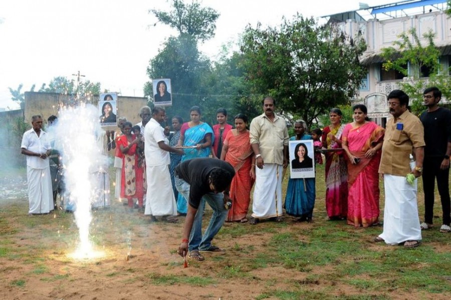 A man lights fireworks as villagers gather to celebrate the victory of US Vice President-elect Kamala Harris in Painganadu near the village of Thulasendrapuram, where Harris' maternal grandfather was born and grew up, in the southern state of Tamil Nadu, India, November 8, 2020. REUTERS/Stringer