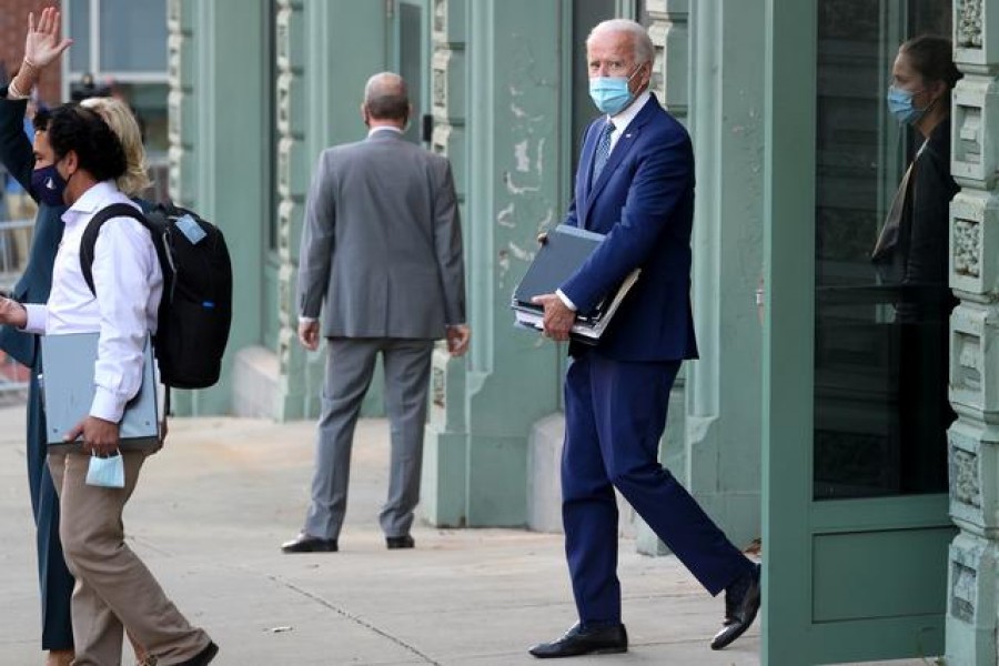 US President-elect Joe Biden carries folders as he departs following meetings on the first day of his transition in Wilmington, Delaware, US, November 9, 2020 — Reuters