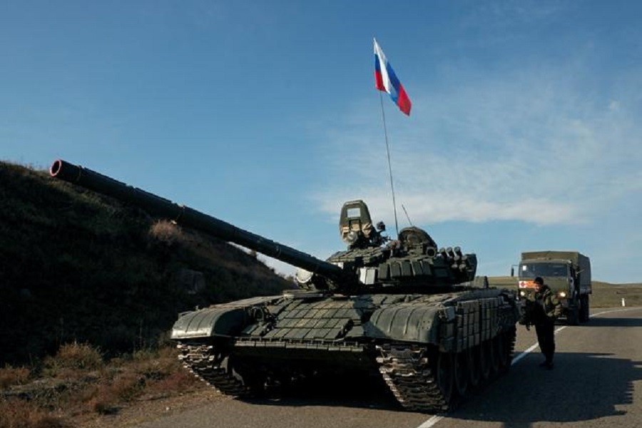 A service member of the Russian peacekeeping troops stands next to a tank near the border with Armenia, following the signing of a deal to end the military conflict between Azerbaijan and ethnic Armenian forces, in the region of Nagorno-Karabakh, November 10, 2020 — Reuters