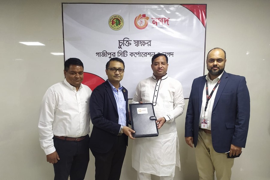 Executive Director of Nagad Md Shafayet Alam (second from left) and GCC Mayor Mohammad Jahangir Alam (second from right) seen exchanging documents on behalf of their respective organisations