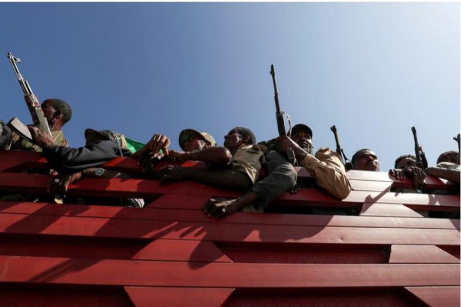 FILE PHOTO: Members of Amhara region militias ride on their truck as they head to the mission to face the Tigray People's Liberation Front (TPLF), in Sanja, Amhara region near a border with Tigray, Ethiopia November 09, 2020. REUTERS/Tiksa Negeri//File Photo