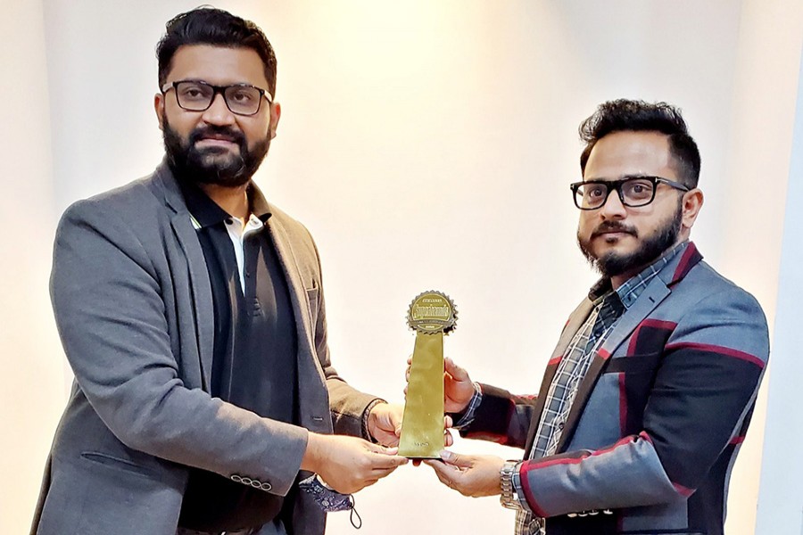 Sajib Mahbub, general manager and executive editor of Bangladesh Brand Forum, handing over the Superbrands award to Golam Morshed, managing director of Walton Hi-Tech Industries Ltd