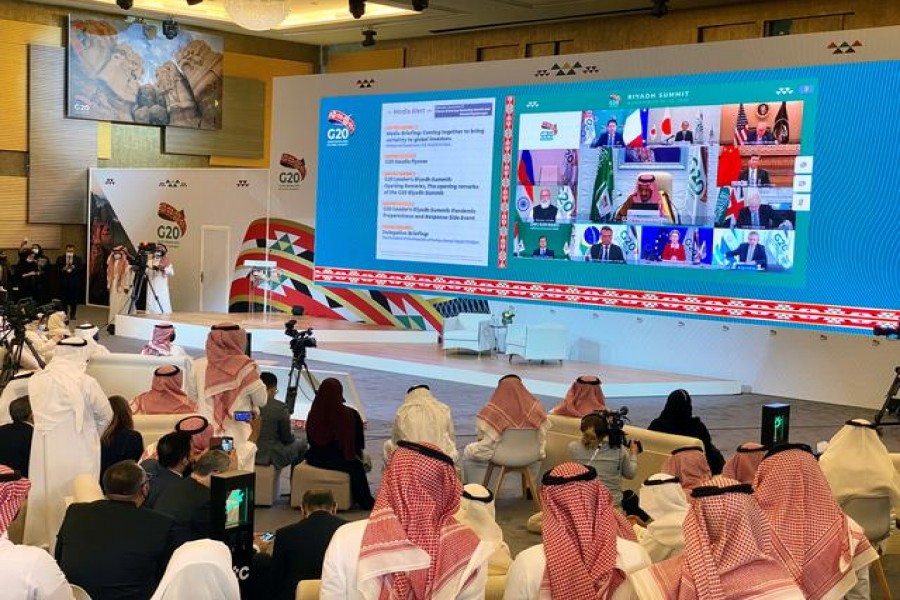 Media watches Saudi King Salman bin Abdulaziz's virtual speech live at the media centre during an opening session of the 15th annual G20 Leaders' Summit in Riyadh, Saudi Arabia November 21, 2020. REUTERS/Nael Shyoukhi