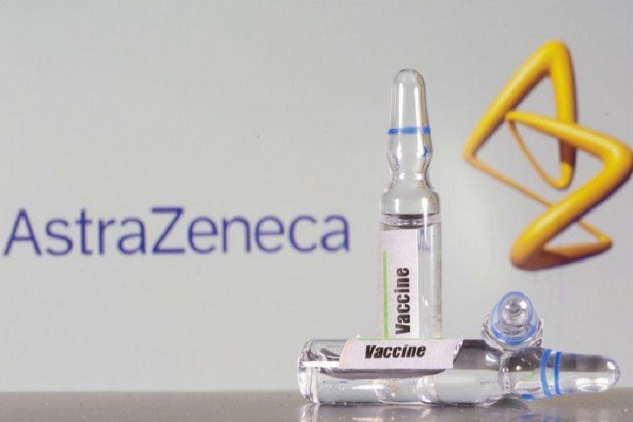 A test tube labeled with the vaccine is seen in front of AstraZeneca logo in this illustration taken, September 9, 2020 — Reuters/Files