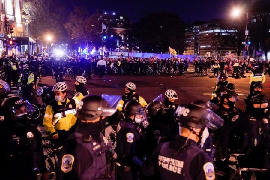 Police officers stand in formation to separate members of the far-right group Proud Boys and counter protesters, in downtown Washington, US, December 12, 2020 — Reuters