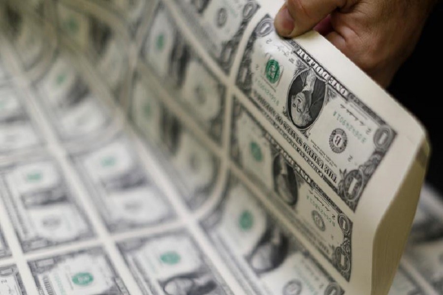 United States one dollar bills are curled and inspected during production at the Bureau of Engraving and Printing in Washington, November 14, 2014 — Reuters/Files