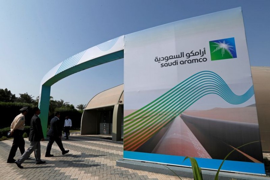 The logo of Aramco is seen as security personnel walk before the start of a press conference by Aramco at the Plaza Conference Center in Dhahran, Saudi Arabia on November 3, 2019 — Reuters/Files