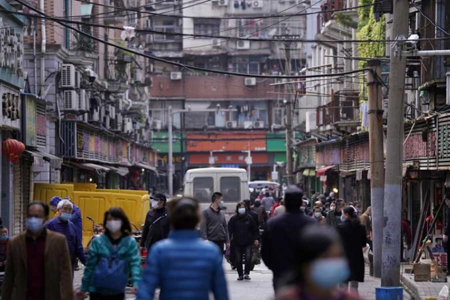  People wearing face masks walking on a street market in Wuhan of China, the epicentre of novel coronavirus disease outbreak. The photo was taken on April 6 this year –Reuters file photo