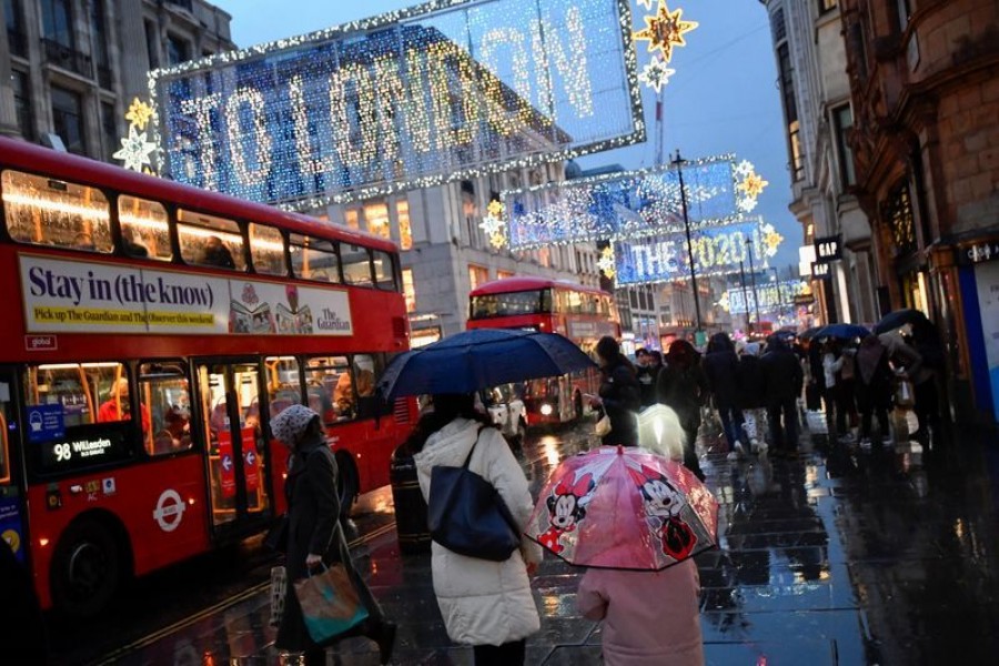 People hold umbrellas as they walk, following the outbreak of the coronavirus disease (Covid-19), in London, Britain on December 16, 2020 — Reuters/Files