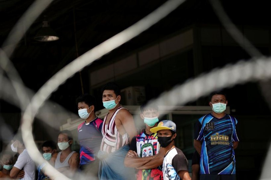 Migrant workers stand in front of a closed shrimp market, amid the coronavirus disease (Covid-19) outbreak, in Samut Sakhon province, in Thailand on December 20, 2020 — Reuters/Files