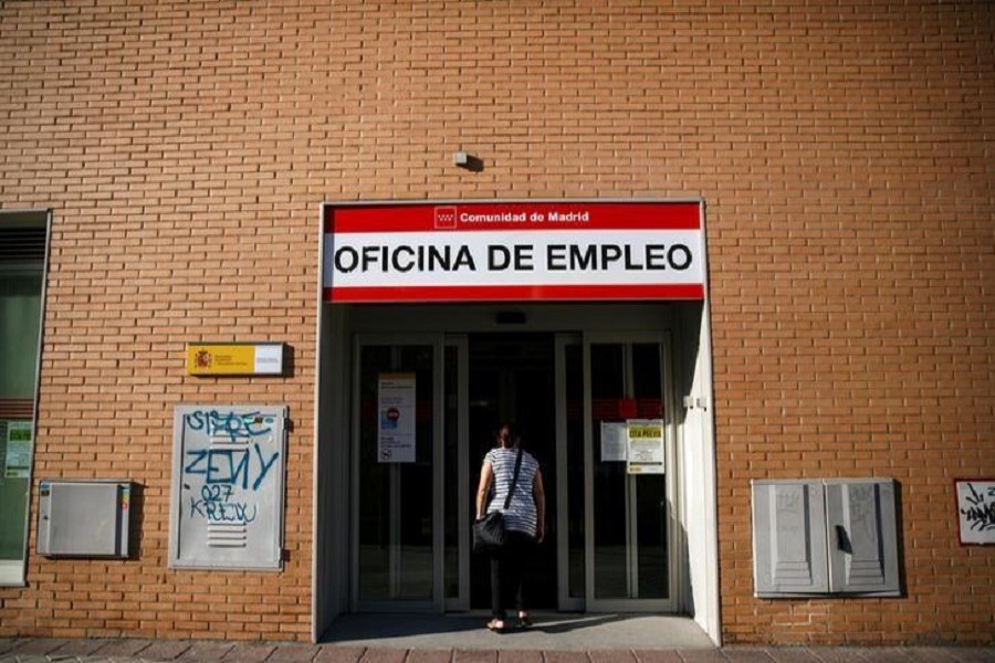 A woman enters a government-run employment office in Madrid July 24, 2014 — Reuters/Files