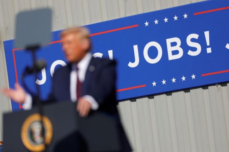 US President Donald Trump speaks in front of a "JOBS! JOBS! JOBS!" banner at a Trump re-election campaign event at Mariotti Building Products in Old Forge, Pennsylvania, US, August 20, 2020. REUTERS/Tom Brenner/Files