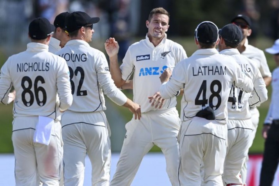 New Zealand's Tim Southee, centre, celebrates his 300th test wicket with teammates after dismissing Pakistan's Haris Sohail during play on day four of the first cricket test between Pakistan and New Zealand at Bay Oval, Mount Maunganui, New Zealand, Tuesday, Dec. 29, 2020. (Andrew Cornaga/Photosport via AP)