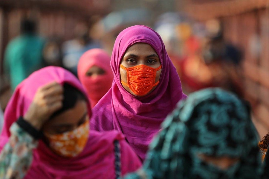 A garment worker wearing a protective mask returns from a workplace as factories reopened after the government has eased the restrictions amid concerns over the coronavirus disease (COVID-19) outbreak in Dhaka, Bangladesh, May 4, 2020 — Reuters/Files