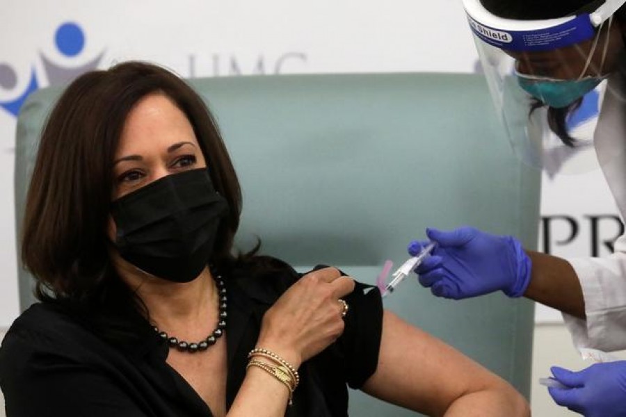 Registered Nurse Patricia Cummings gives US Vice President-elect Kamala Harris a dose of the Moderna Covid-19 vaccine at United Medical Center in Washington, US, December 29, 2020. REUTERS/Leah Millis