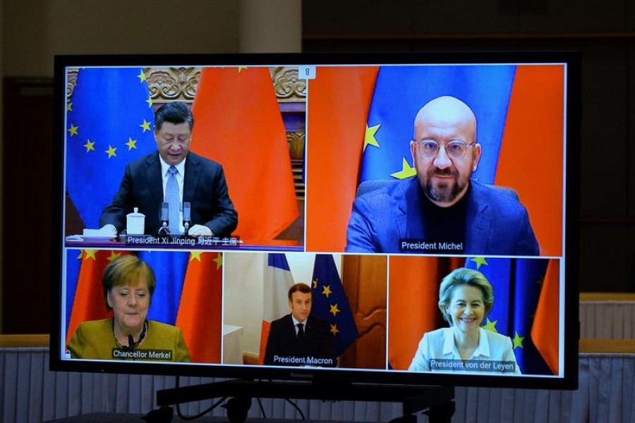 European Commission President Ursula von der Leyen, European Council President Charles Michel, German Chancellor Angela Merkel, French President Emmanuel Macron and Chinese President Xi Jinping are seen on a screen during a video conference, in Brussels, Belgium, December 30, 2020 — Reuters