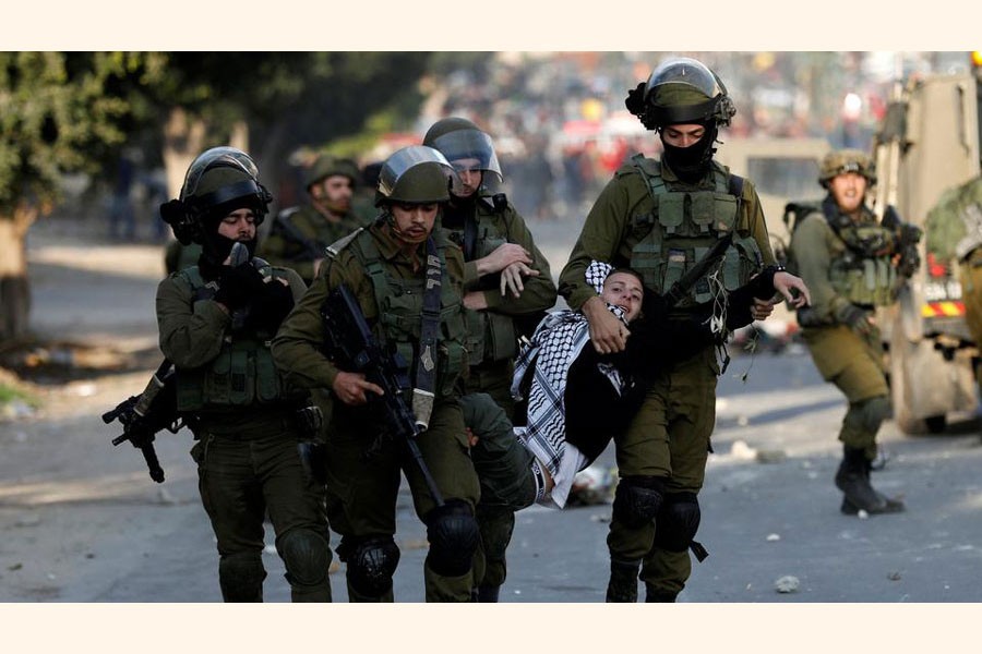 Israeli soldiers detain a Palestinian youth during a protest against US President Donald Trump's decision to recognise Jerusalem as the capital of Israel, near the West Bank city of Nablus December 15, 2017     —Reuters