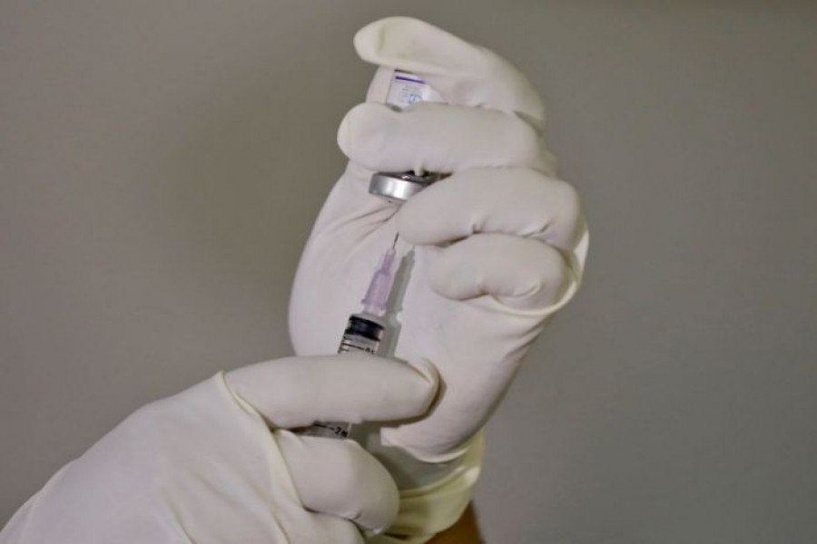 A paramedic fills a syringe with a vaccine against the coronavirus disease (COVID-19) before administering it to a health worker during its trials at Civil Hospital in Ahmedabad