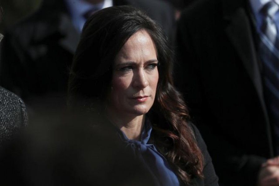 White House Press Secretary Stephanie Grisham listens to US President Donald Trump talk to reporters as he departs for travel to Georgia from the South Lawn of the White House in Washington, US, November 8, 2019. REUTERS/Leah Millis/File Photo