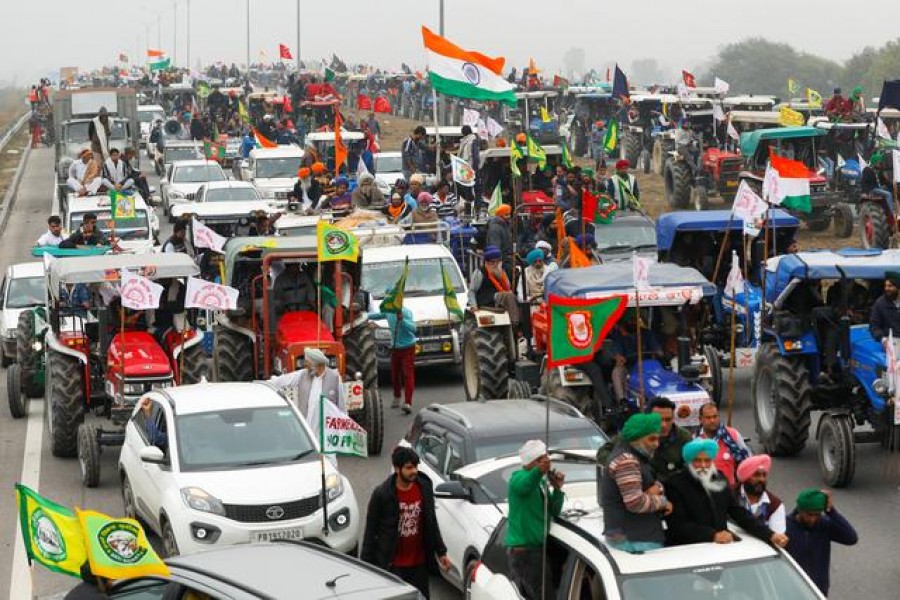 FILE PHOTO: Farmers participate in a tractor rally to protest against the newly passed farm bills, on a highway on the outskirts of New Delhi, India, January 7, 2021. REUTERS/Adnan Abidi