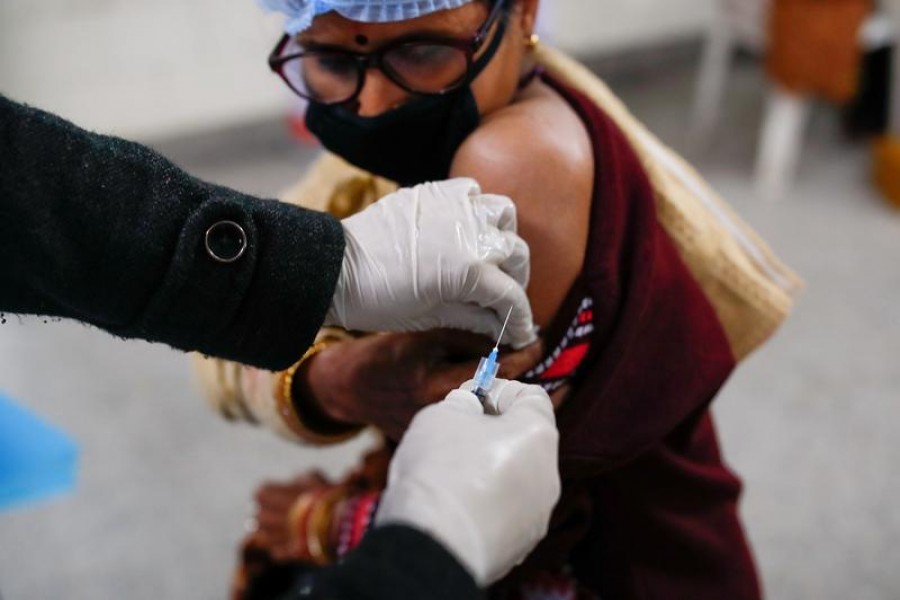 A health worker and a volunteer take part in a nationwide trial run of coronavirus disease (Covid-19) vaccine delivery systems, inside a school, which has been converted into a temporary vaccination centre, in New Delhi, India, January 8, 2021 — Reuters/Files