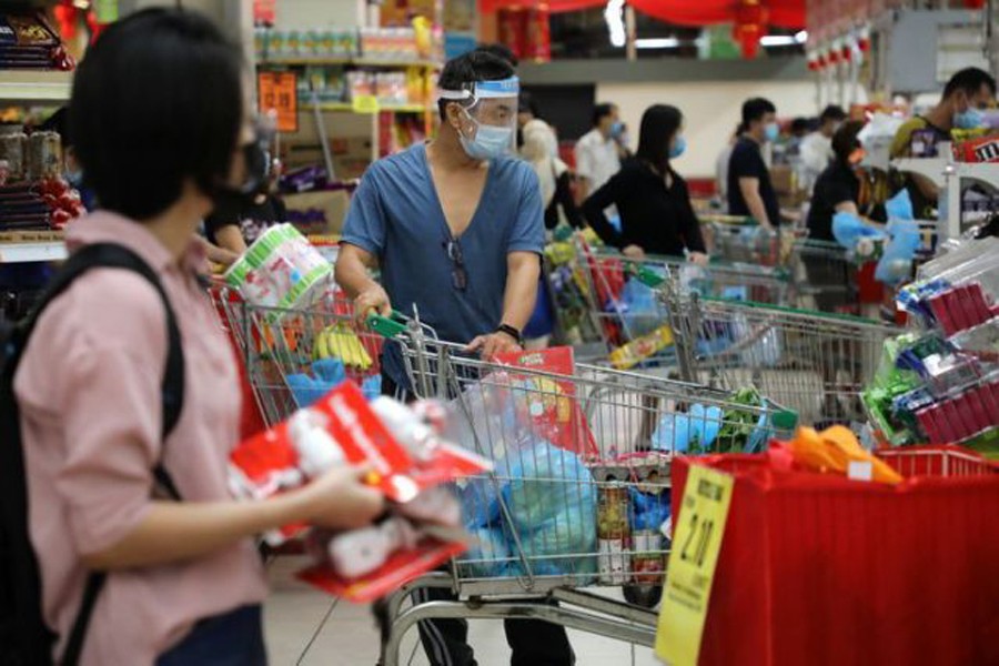 People line up to pay at a supermarket, amid the coronavirus disease (Covid-19) outbreak in Kuala Lumpur, Malaysia on January 12, 2021 — Reuters photo