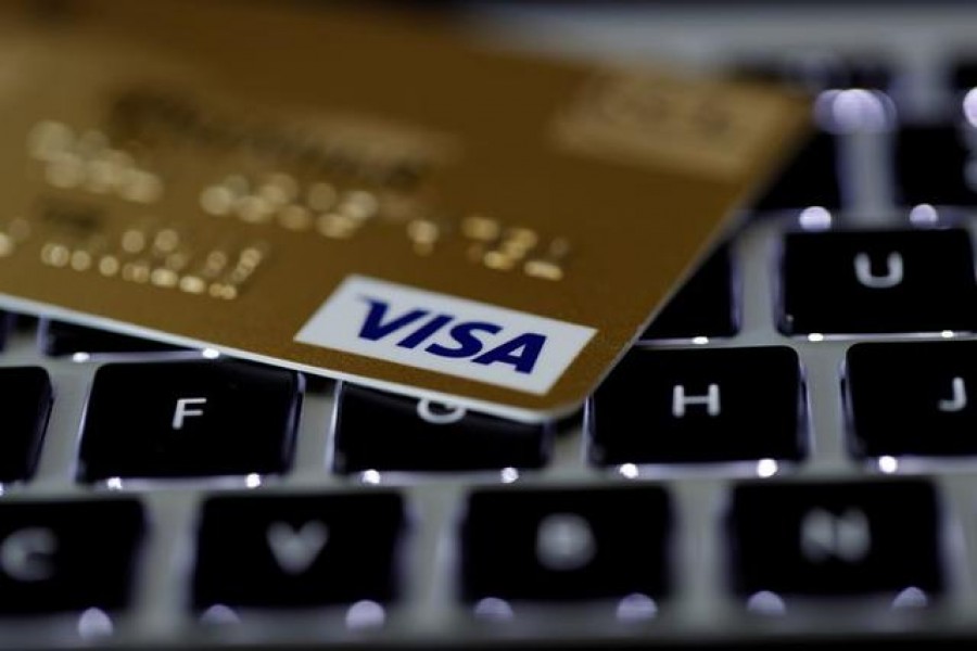 FILE PHOTO: A Visa credit card is seen on a computer keyboard in this picture illustration taken September 6, 2017. REUTERS/Philippe Wojazer/Illustration