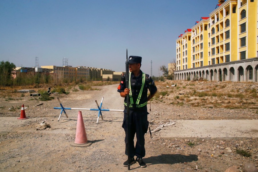 A Chinese police officer takes his position by the road near what is officially called a vocational education center in Yining in Xinjiang Uighur Autonomous Region, China, September 4, 2018. REUTERS