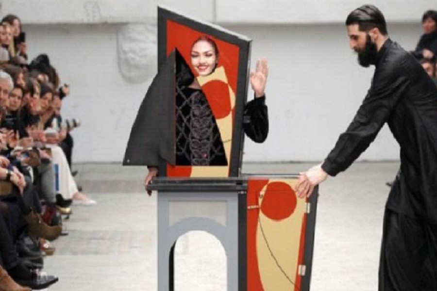 A magician performs with a model who presents a creation by Indian designer Manish Arora as part of his Fall-Winter 2011/2012 women's ready-to-wear fashion collection during Paris Fashion Week March 3, 2011 — Reuters/Files