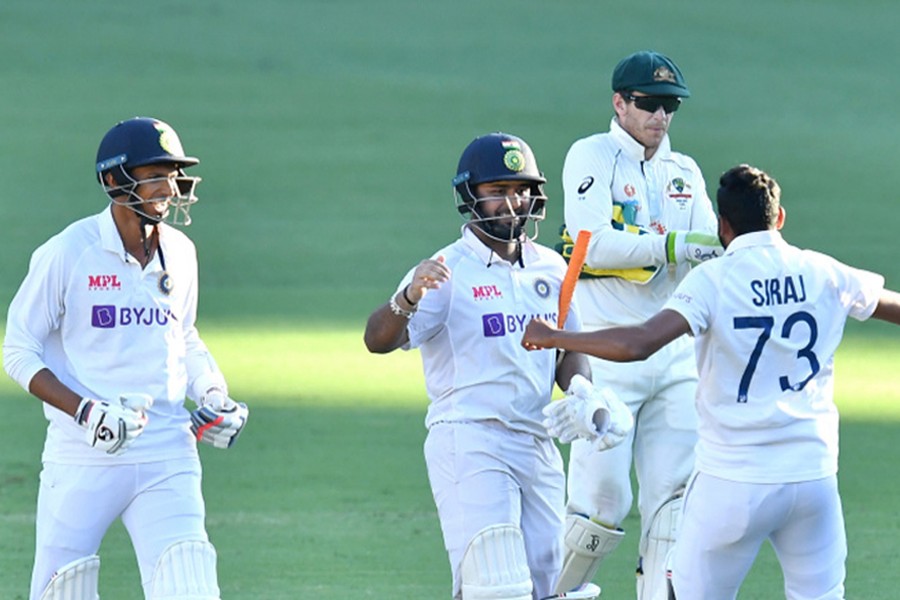 Rishabh Pant of India celebrates with teammates Navdeep Saini and Mohammed Siraj after winning the fourth Test match against Australia — AAP photo via Reuters