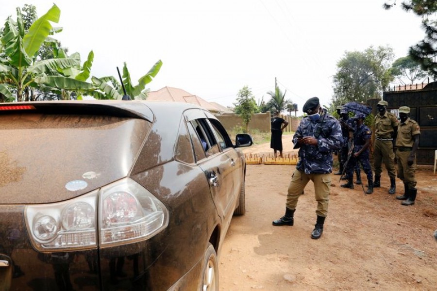 Ugandan police officers refuse lawyers of Ugandan opposition presidential candidate Robert Kyagulanyi, also known as Bobi Wine, from meeting him at his house in Kampala, Uganda January 18, 2021. REUTERS/Baz Ratner