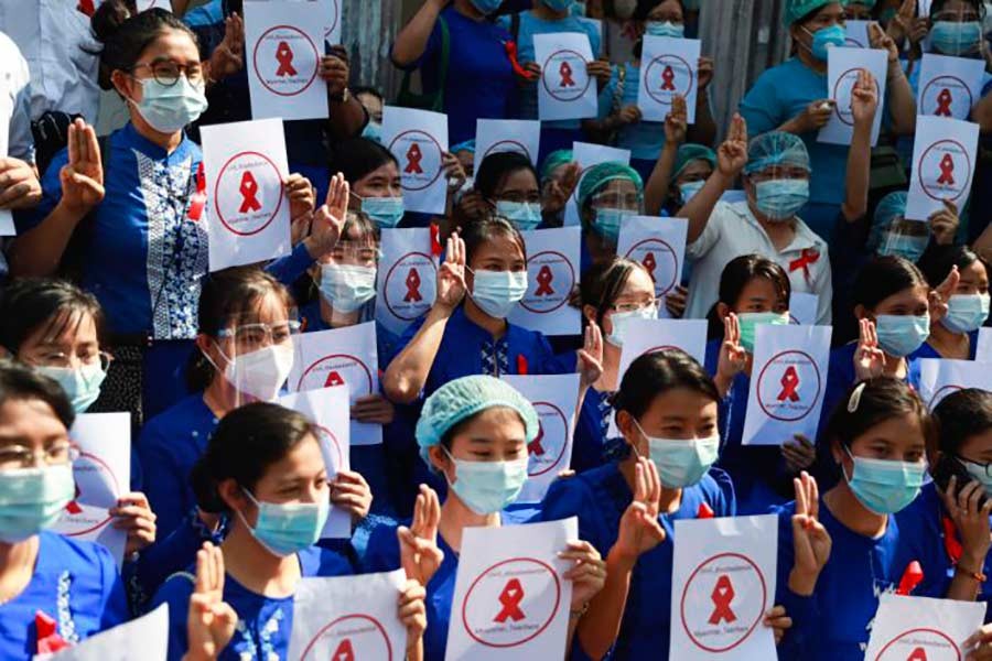 Teachers from Yangon University of Education wear red ribbons and pose with a three-finger salute as they take part in demonstration against the military coup in Myanmar -Reuters photo