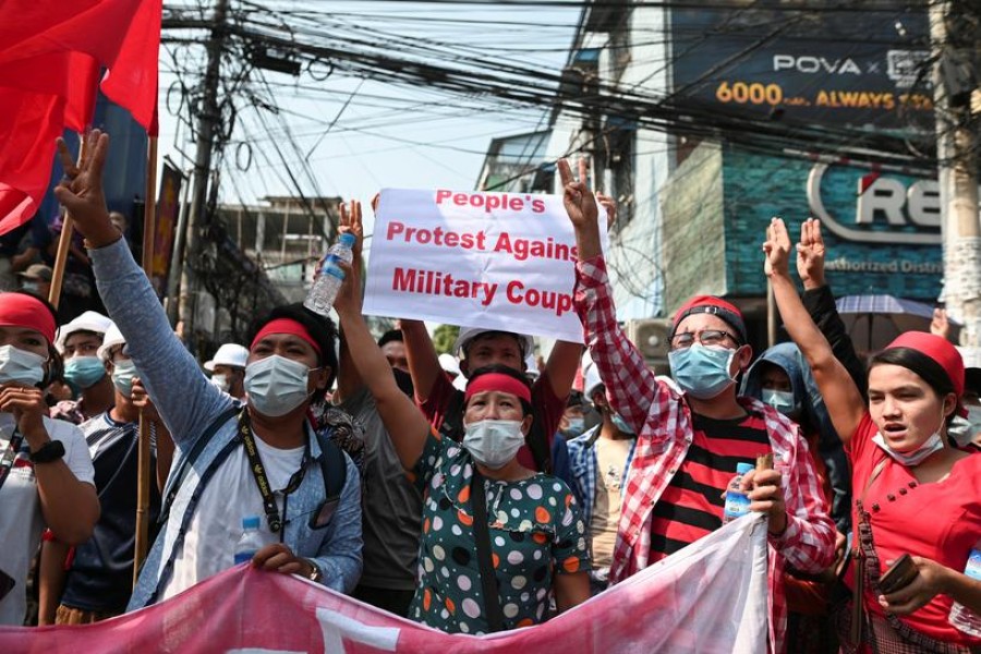 Demonstrators show the three-finger salute to protest against the military coup and demand the release of elected leader Aung San Suu Kyi, in Yangon, Myanmar on February 6, 2021 — Reuters photo