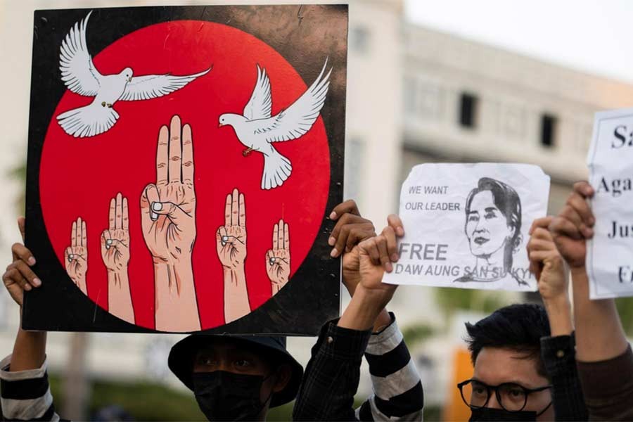 People hold up placards as they join a rally to protest against the military coup and to demand the release of elected leader Aung San Suu Kyi, in Yangon of Myanmar on Monday -Reuters photo