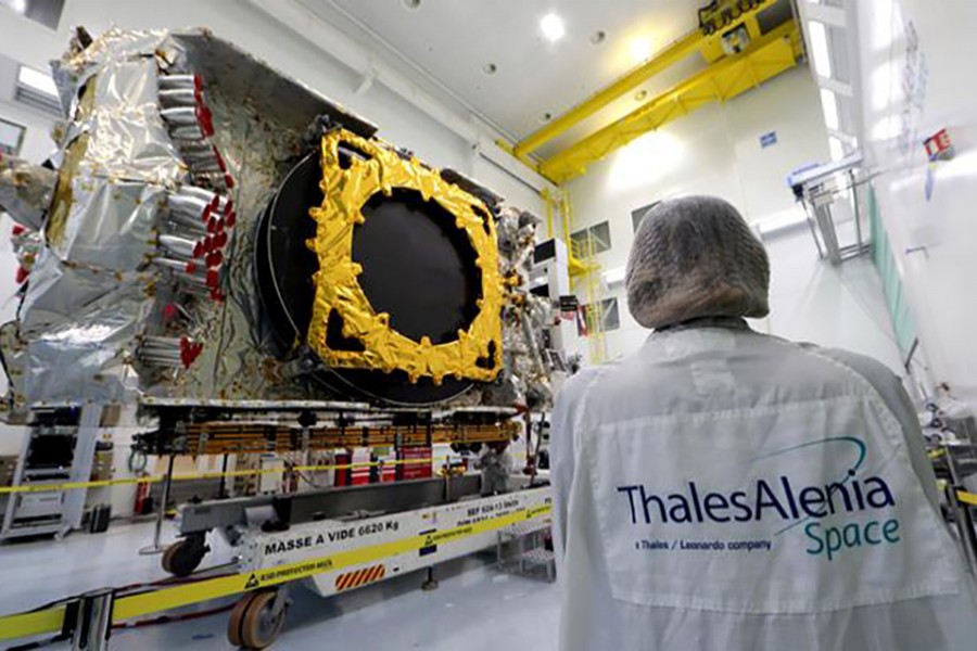 A technician stands next to the all-electric Konnect communications satellite, which will be shipped to the Guiana Space Center in Kourou, in the clean room facilities at the Thales Alenia Space plant in Cannes, France on November 22, 2019 — Reuters/Files