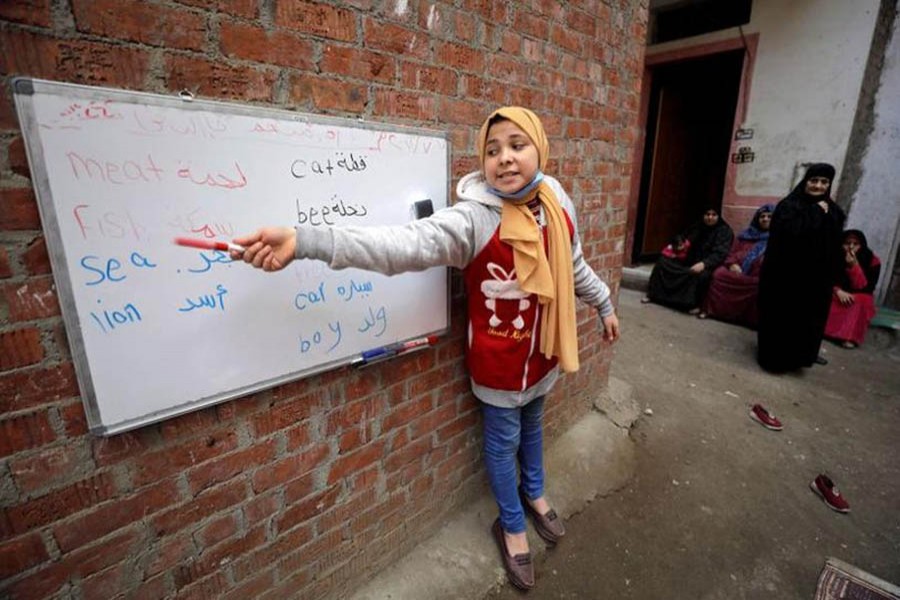 Reem El-Khouly, a 12-year-old girl, teaches children in Dakahlia province, Egypt