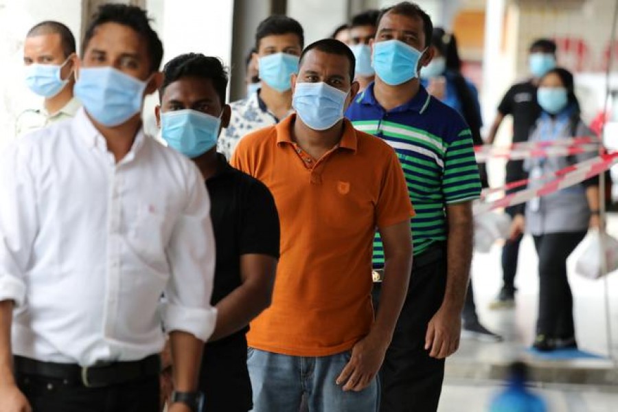 Foreign workers wait in line to be tested for the coronavirus disease (Covid-19) outside a clinic in Kajang, Malaysia on October 26, 2020 — Reuters/Files